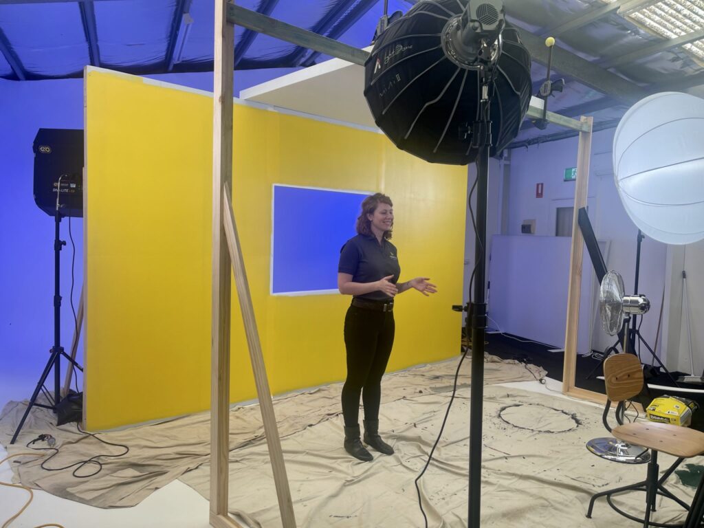 Television Commercial Production — behind‑the‑scenes studio setup with camera crew and lighting.